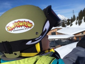 Child wearing a helmet on ski lift